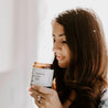 9oz Coastal Rainfall Soy Candle being held by a woman. 