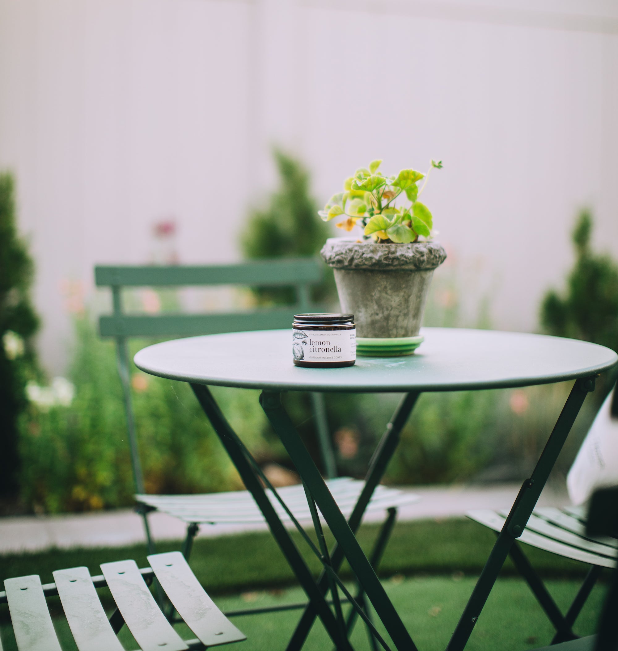 Lemon Citronella Incense Cone Kit on a small outdoor patio table. 