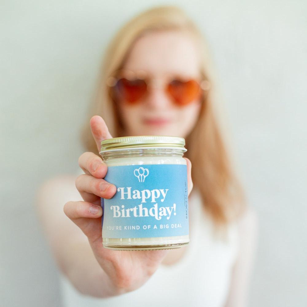 9oz 'Happy Birthday' Soy Candle being held by a young woman. 