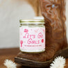 9oz 'Let's Go Girls' Soy Candle on a cowboy boot. 