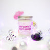 'Not Santa's First Rodeo' 9oz Soy Candle next to mini disco balls and cowboy hats. 