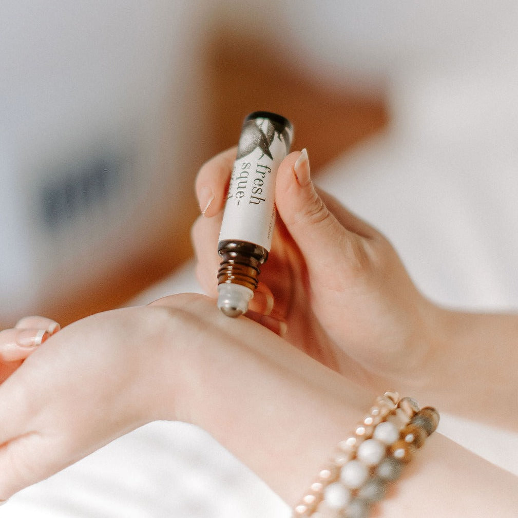 Fresh Squeezed Roll-On Perfume being applied to a wrist. 