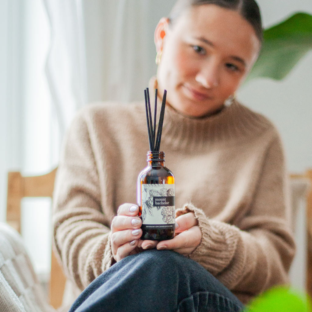 Mount Bachelor Reed Diffuser being held by a woman. 