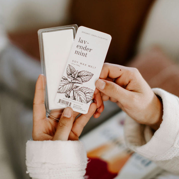 Lavender Mint Soy Wax Melt being held by two hands. 