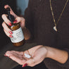 8oz Mount Bachelor Body Lotion being dispensed into a woman's hands. 