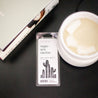 Saguaro Cactus Soy Wax Melt on black side table next to a white wax melter and stack of books.  