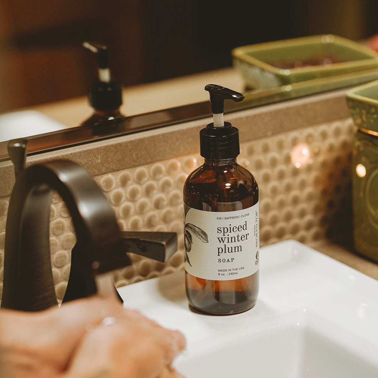 8oz Spiced Winter Plum Liquid Soap next to bathroom sink. 